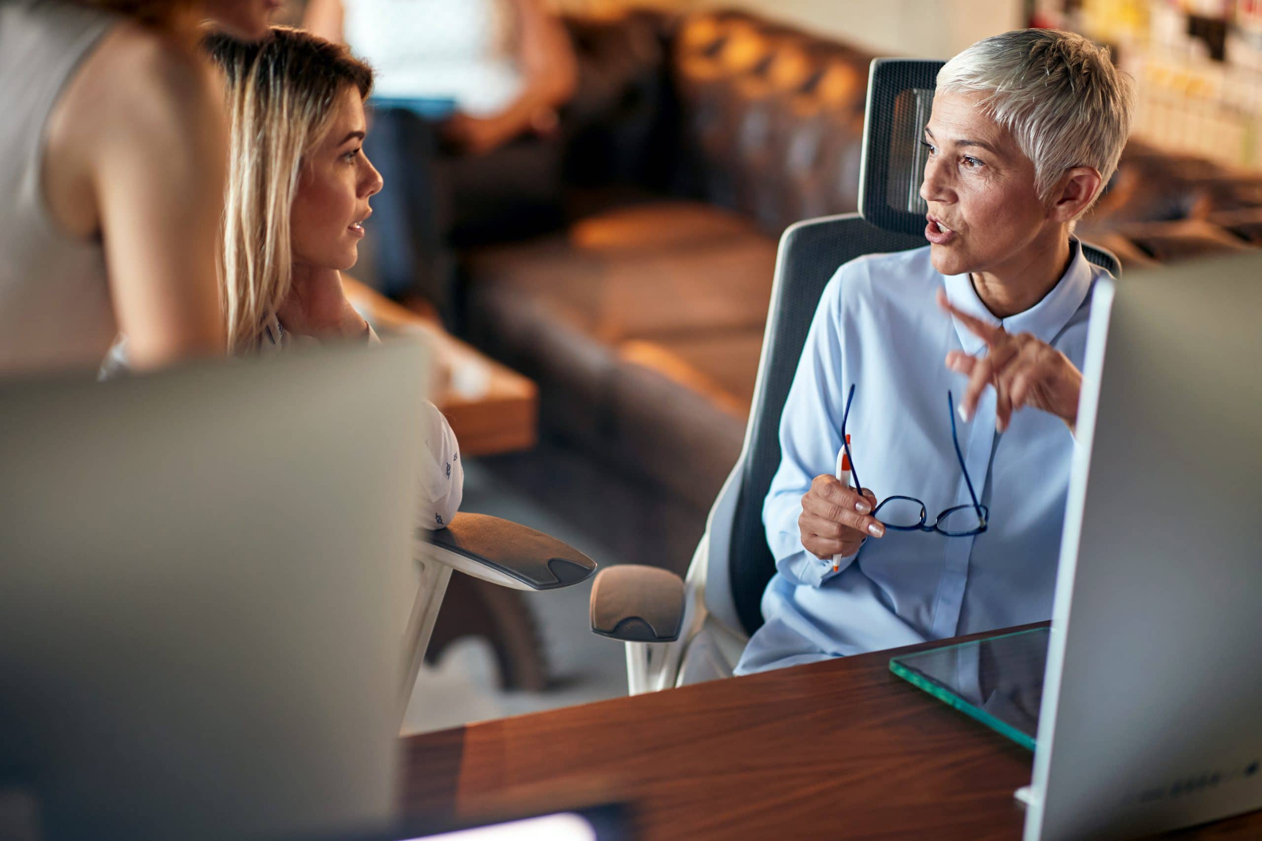 Young women being mentored by senior successful businesswoman