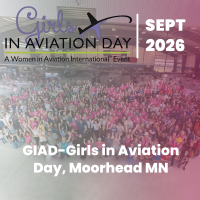 Group photo of attendees at GIAD—Girls in Aviation Day, Moorhead MN, inside an airport hangar with event branding overlay and pink gradient.